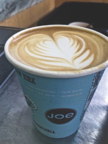 Claire stops to order a vanilla latte with Joe Coffee's signature foam latte art.