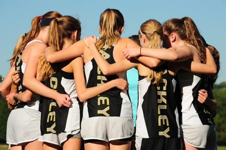 The Girls XC team joins in a pre-race huddle. Photo by Coach Garfield. 