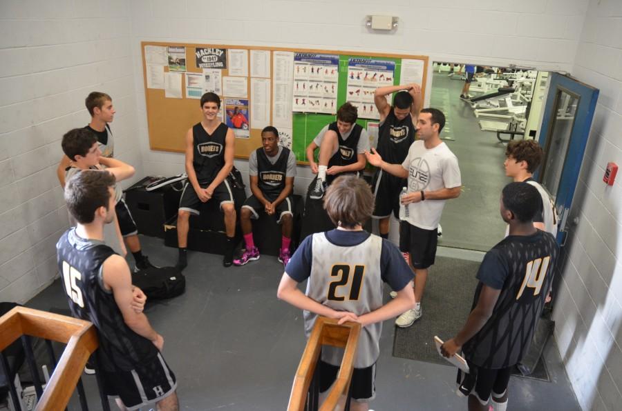 The boys basketball team huddles together to go over different plays before heading off to practice. Photo by Angela Mauri.