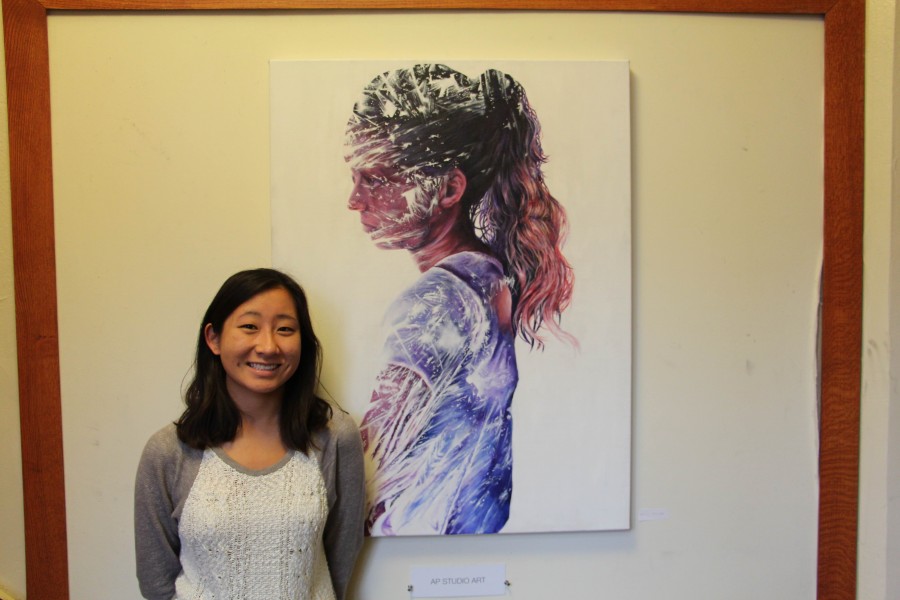 Erin poses with one of her latest paintings.