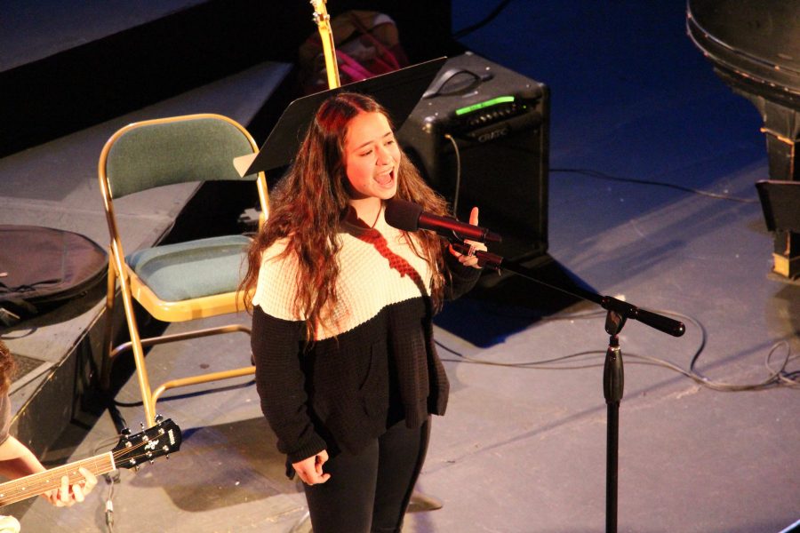 Sophomore Mia Boemio belts out one final note in her Winter Coffeehouse performance.