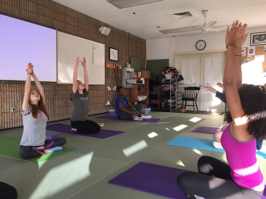 Upper School students participate in yoga as a Physical Education class. The new program has expanded yoga beyond its traditional offerings.