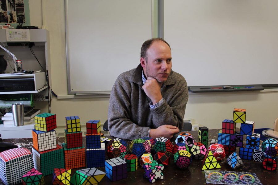 Mr. Gruenberg surrounds himself with his Rubik’s Cubes while pondering his next move.