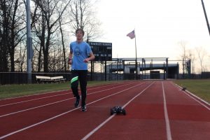 Senior Alex Popov tests out his pacing car on the track at Hackley. He built this car to help him train more efficiently by keeping him on a constant pace.