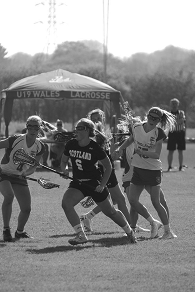 Meghan playing midfield for the Scottish national team.