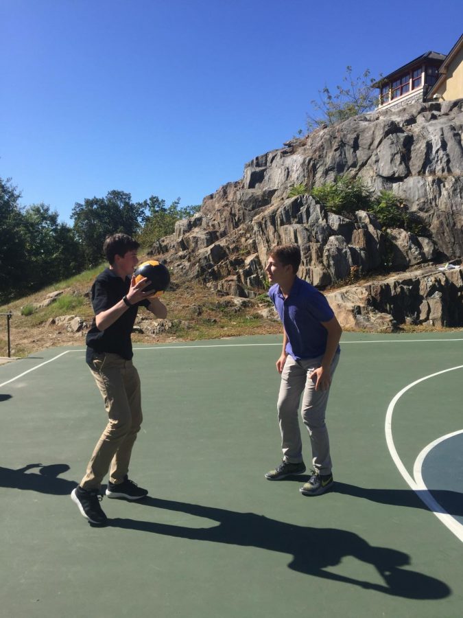 Henry practices his moves on the basketball court against sophomore Patrick Schulman.