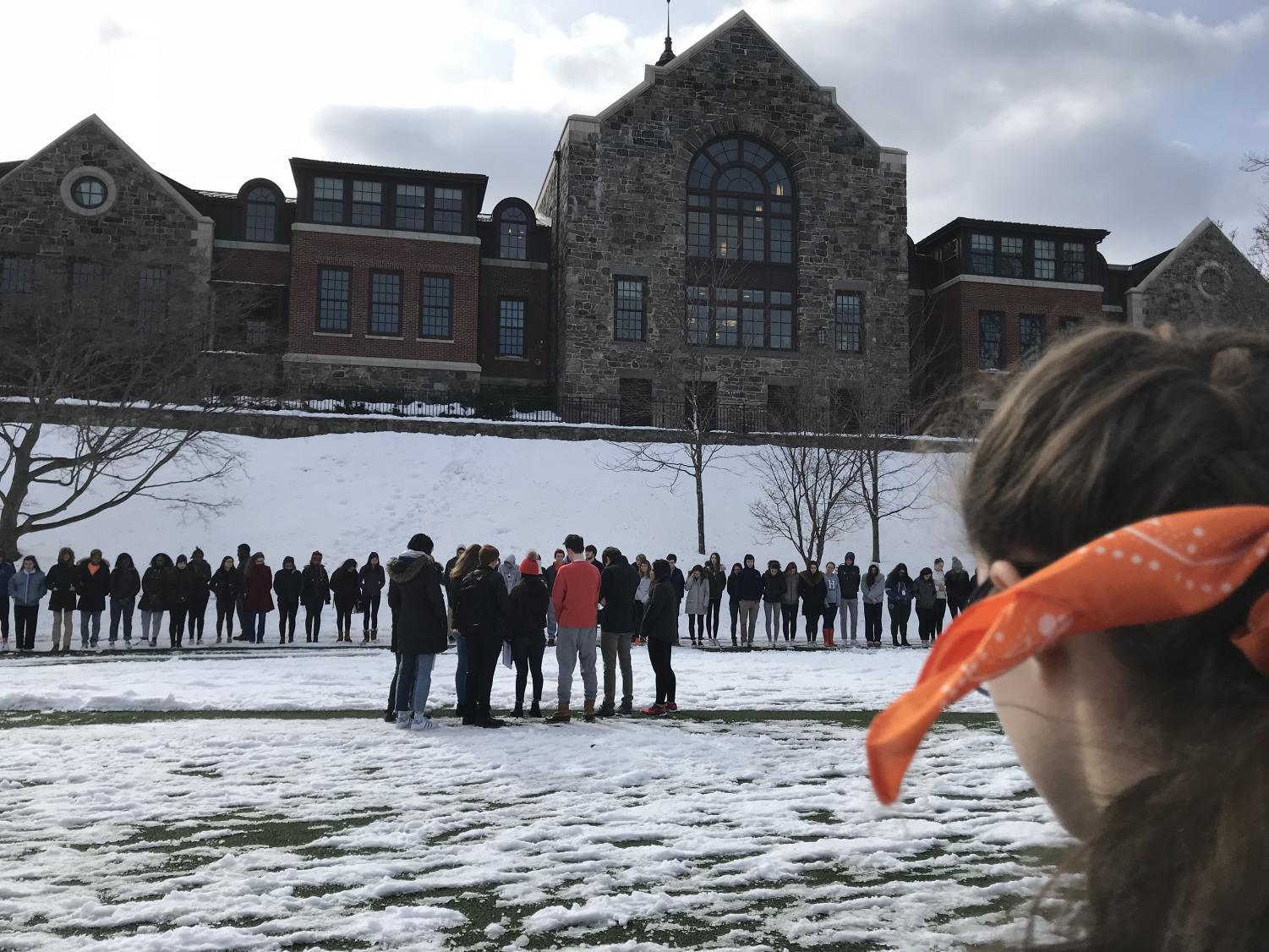 Students and faculty gather around akin common for a 34 second moment of silence.