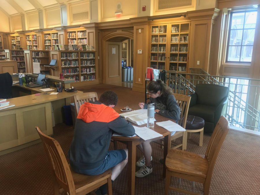 As the school year winds down, students study in the Goodhue Library. The end-of-year testing schedule prevents students from becoming overwhelmed with assessments and helps spread out their work productively. Some students still feel stressed about the amount of work they still have to complete before school ends, though. 