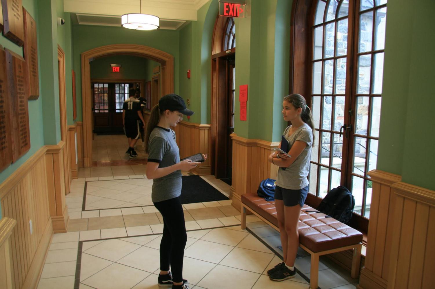 Sadie Friesen and Amanda Mooney practice presenting their speeches. The juniors crafted and presented speeches on topics of their choice on First Friday. Speech writing and presenting is a junior First Friday tradition.
