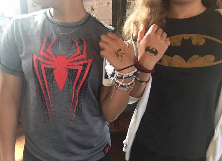 Sophomores Nina Mital and Sadie Nipon show off their tattoos. Council gave out superhero tattoos in the Grille Room on Superhero day. 