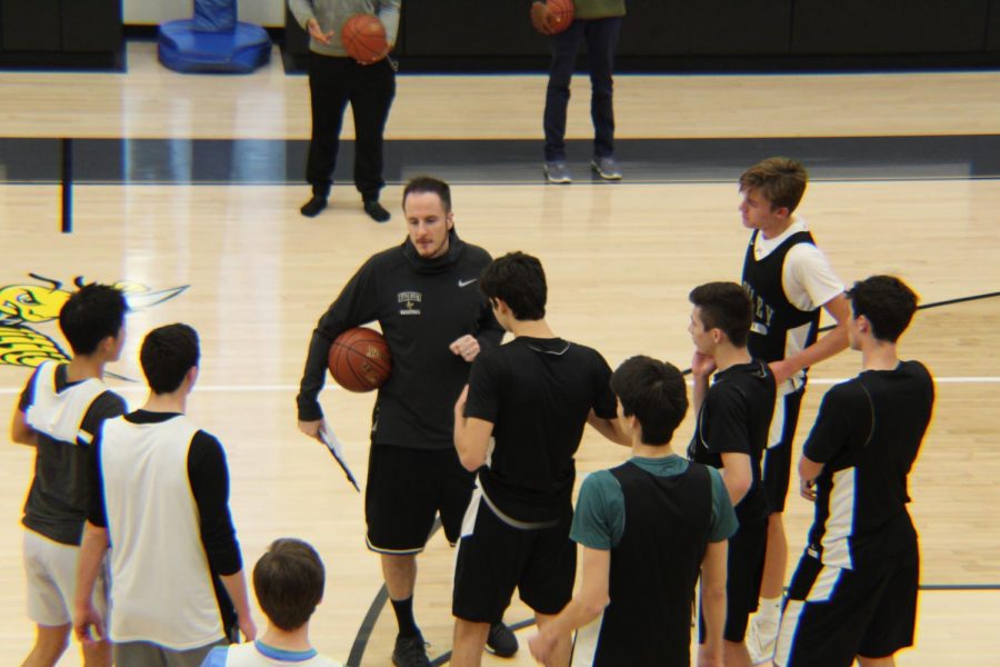 Coach Kuba explains a drill to the team. He emphasizes quick ball movement to the team in practice. This is Coach Kuba’s first season coaching the boys’ varsity basketball team.
