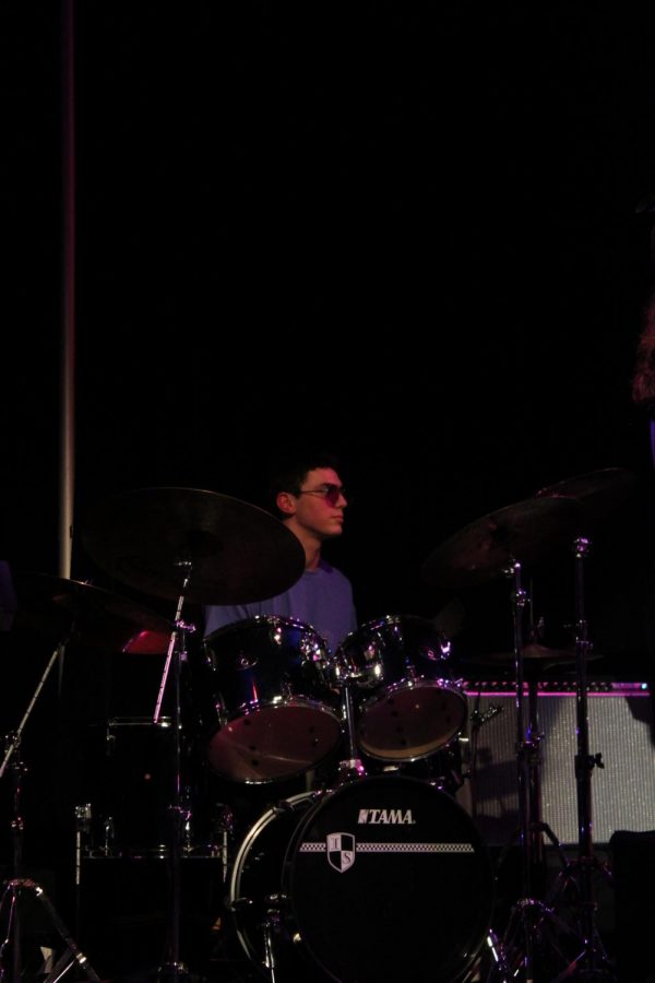 Senior Ben Monroe plays the drums in the house band.