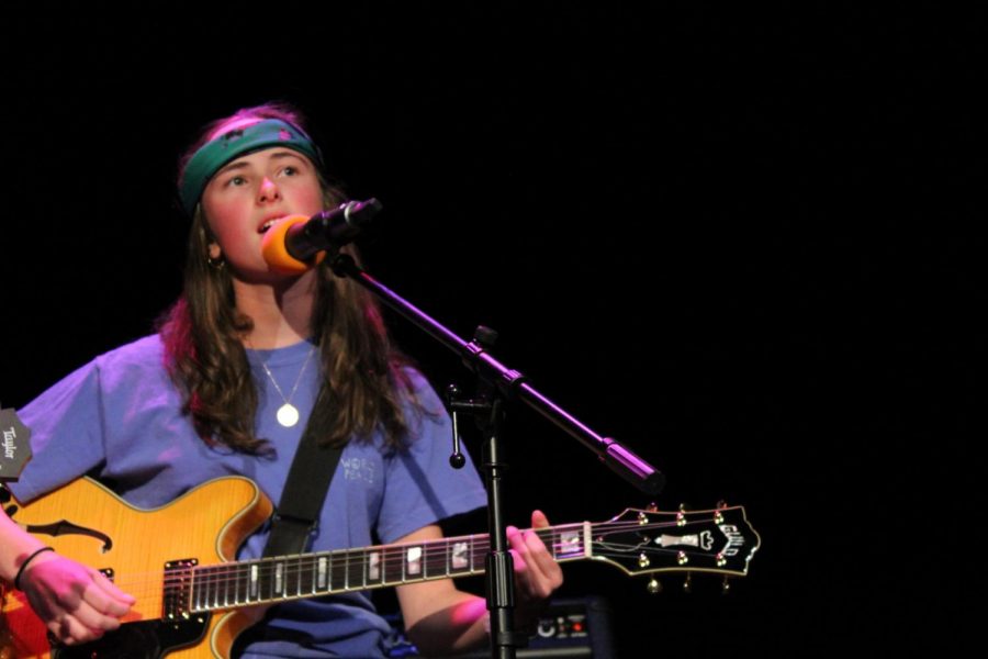 Junior Maggie Broaddus plays guitar in the house band.