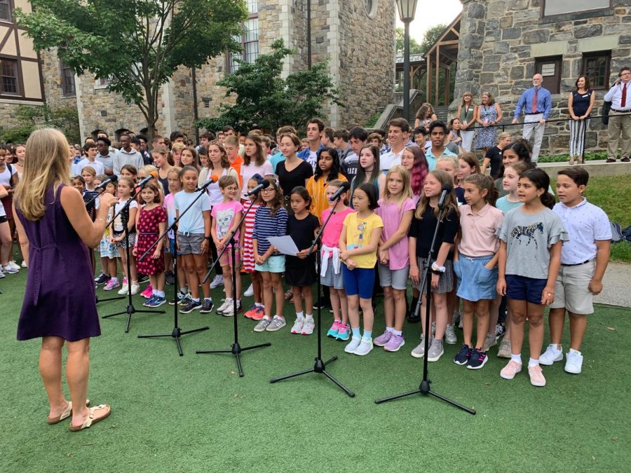 Upper School chorus teacher May Steinberg directs lower and upper school chorus students in their singing of the Hackley Alma Mater. The song was followed by speeches from Taylor Robin and Head of School Mr. Wirtz. This tradition marks the beginning of the school year which is bookended by a Commencement ceremony.