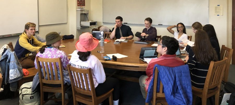 Students in the independent research course meet with Mr. Flanigan to talk about their respective topics. At this point in the year, class members have compiled sources that have helped them to learn more about their historical and literature interests.