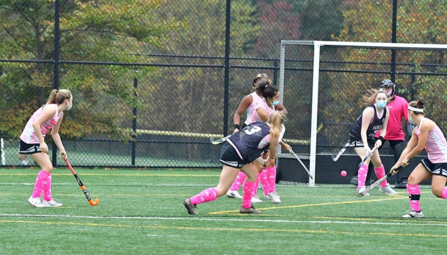 Varsity girls field hockey plays in a pink out game. This is a tradition that takes place every year, and was modified with masks.