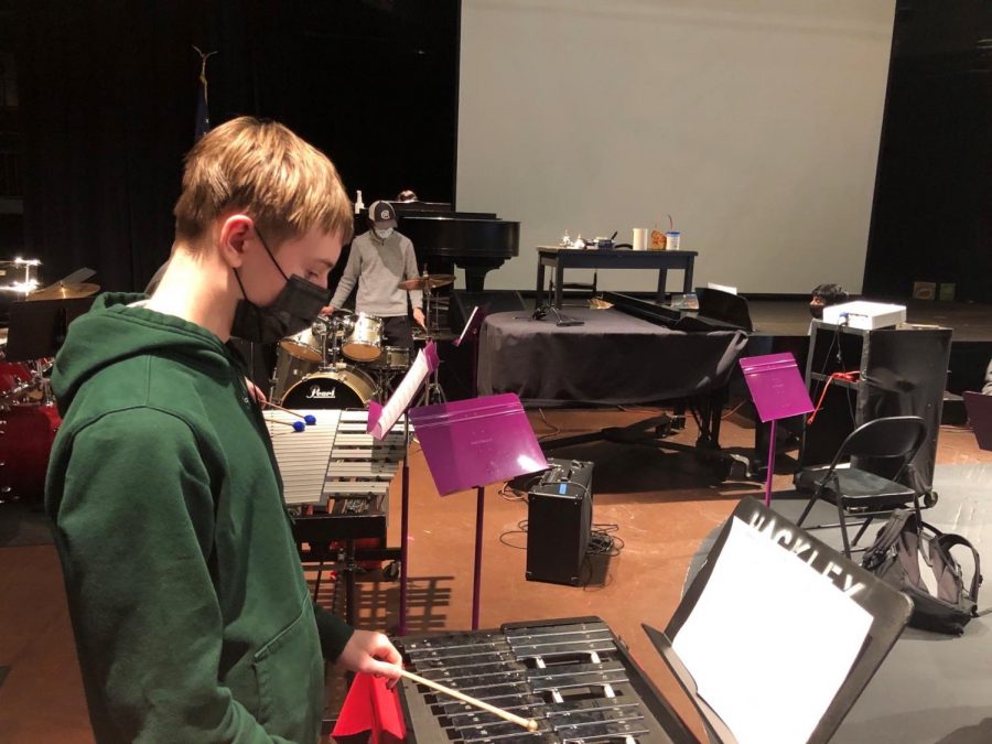 Freshman Jake Byrne plays a xylophone and Lucas Caramanica plays a drum set. COVID-19 restrictions have forced students in band to make music in a different way than they did before the pandemic.