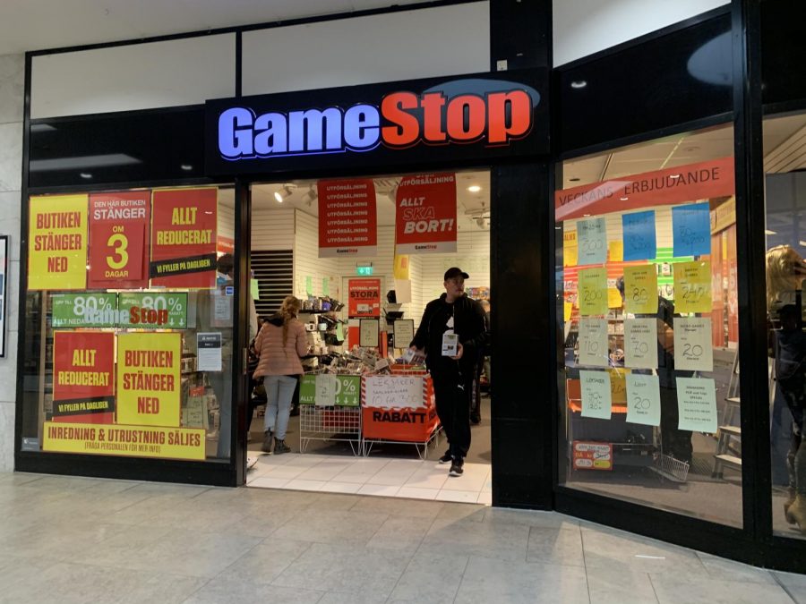 Customers walk out of gamestop, the recent focus of a financial fiasco on Wall Street.