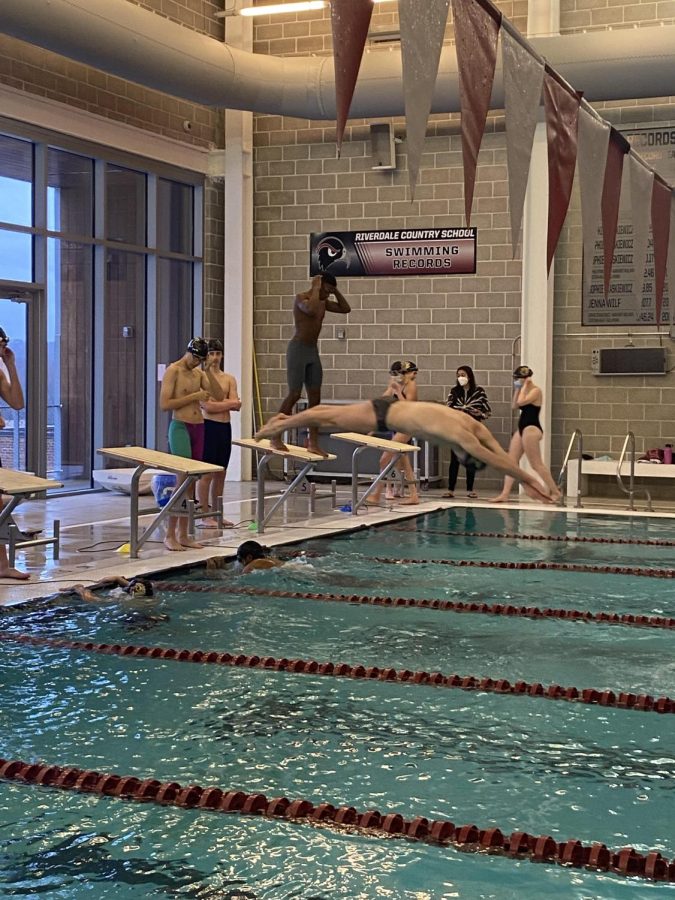 Max Hardart, senior, takes off to compete against Riverdale in their swim meet.