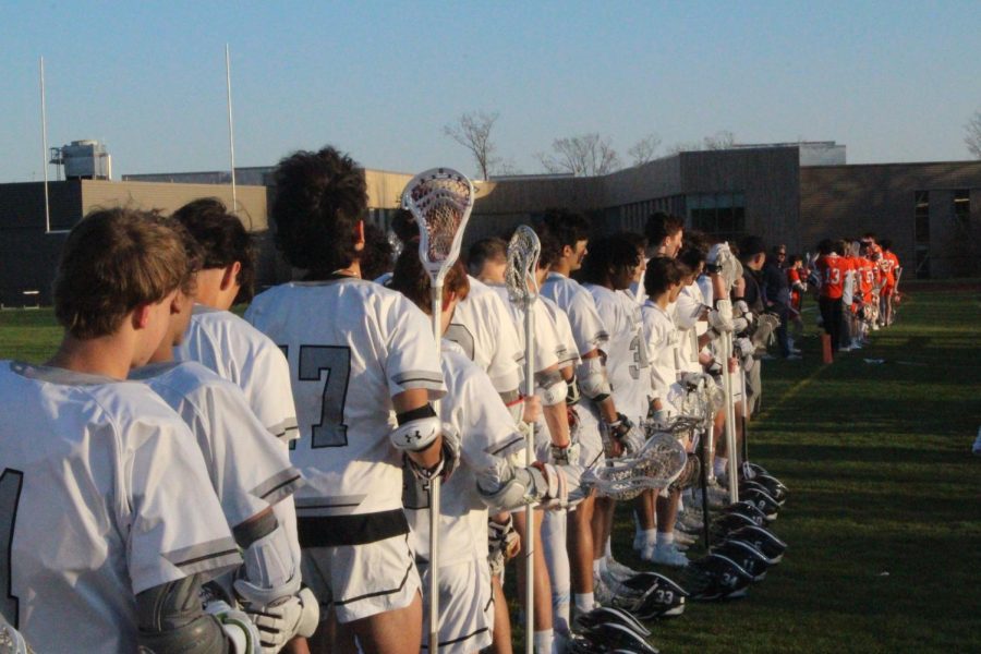 Hackley and Fieldston players line up for the National Anthem before getting ready to play. Junior defenseman Will Maier commented on this treasured pregame ritual, Its a powerful tradition, and represents an important message of teamwork, patriotism, and sportsmanship. 