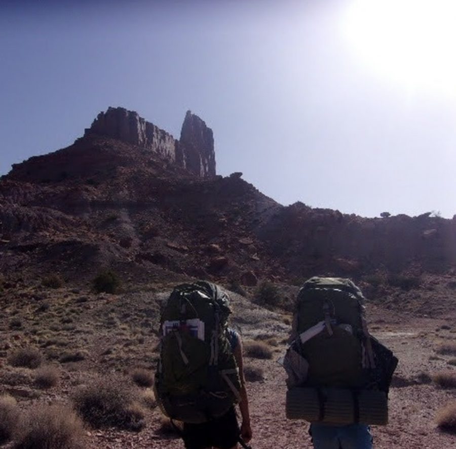 Alex and a companion backpack through the canyonlands on expedition, carrying their entire livelihoods on their backs.