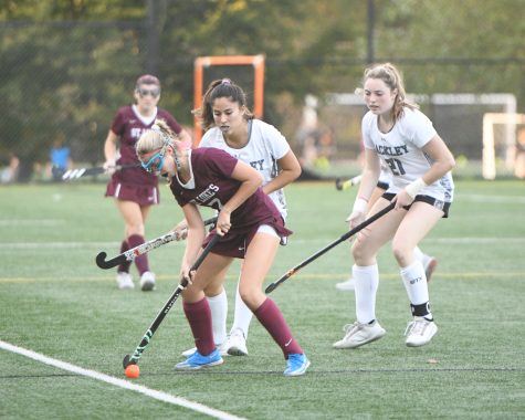 Lucia Monteleone 23 and Catie ORourke 23 are teaming up to trap the St. Lukes player. They are trying to prevent her from passing the ball to one of her teammates so that Hackley can gain possession.