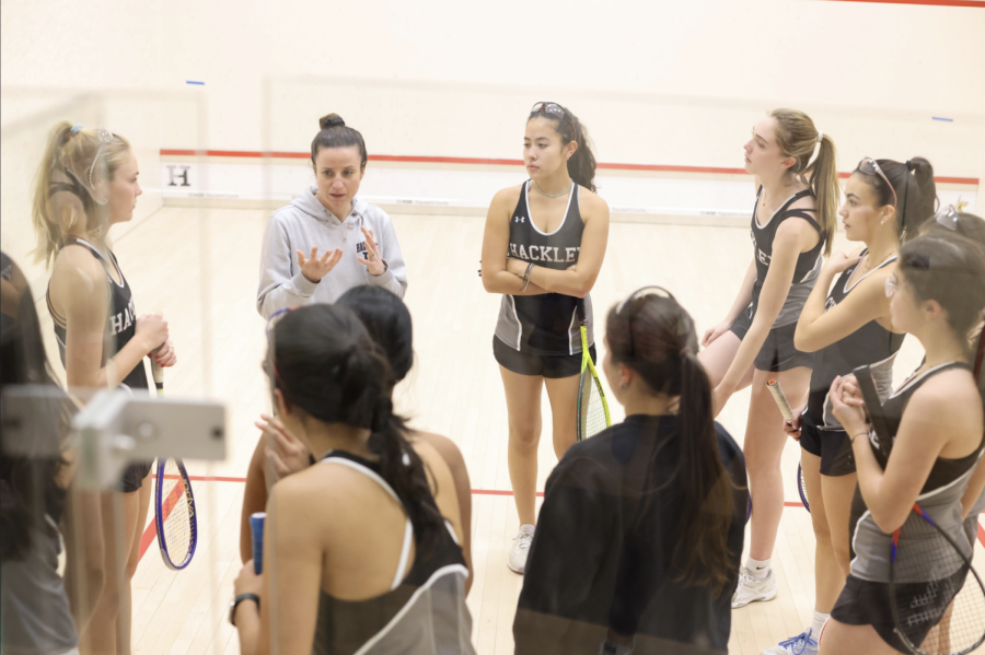 Girls squash debriefs with coach Rix after a strong win against Horace Mann. The girls always have a debrief talk with captains at the end of every match.