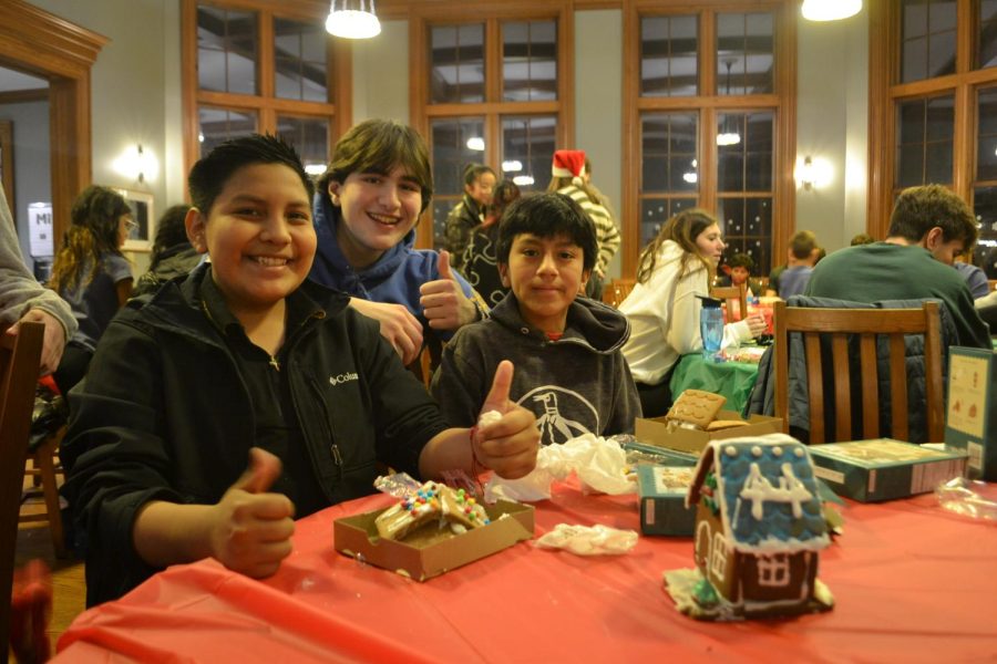 Senior Tibet Yakut and 8th grade scholars Michael and Levi hard at work on their gingerbread houses. This station was a hit among everybody, even though it got a little messy!