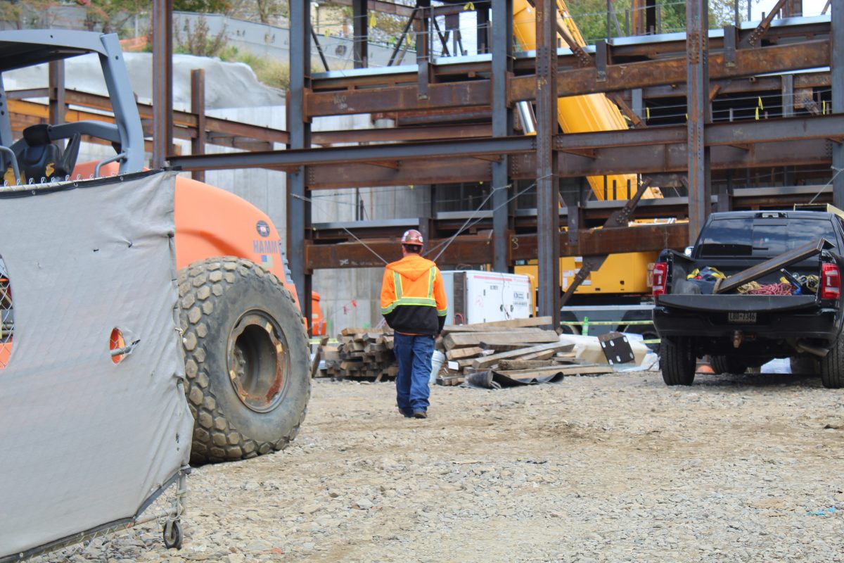 One of many construction workers walk towards the developing Center of Creative Arts and Technology. The construction is planned to finish sometime in 2024, mere months away.