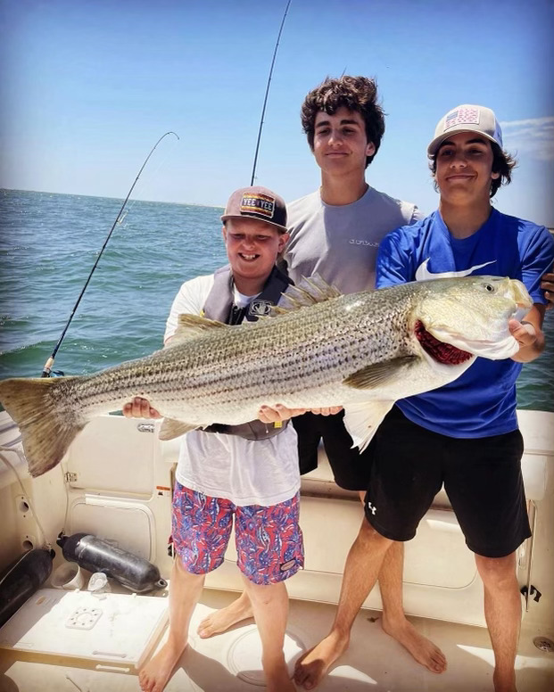 Conor(middle) poses with his big catch off the coast of Florida. Conor hopes to bring his experience and skills to help members improve their fishing abilities.