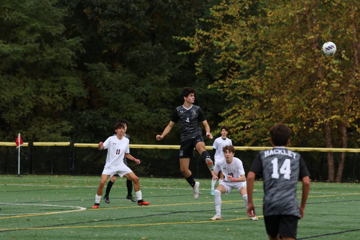 Sophomore Andrew Carpenito heads the ball away from the defense. Boys Soccer played Rye Country Day. The game started at 2:45 p.m and after a hard fought game they lost, 1-0.
