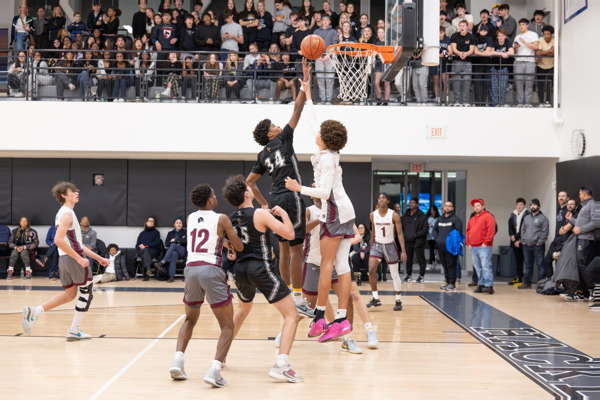 Sophomore+Jelani+Middleton+scores+a+basket+in+the+third+quarter+of+the+boys+varsity+basketball+game+against+Riverdale+Country+School.+Students+packed+the+stands+to+cheer+on+their+classmates+with+parents+watching+below+on+court.+This+years+Sting+game+featured+appearances+from+NBA+players.