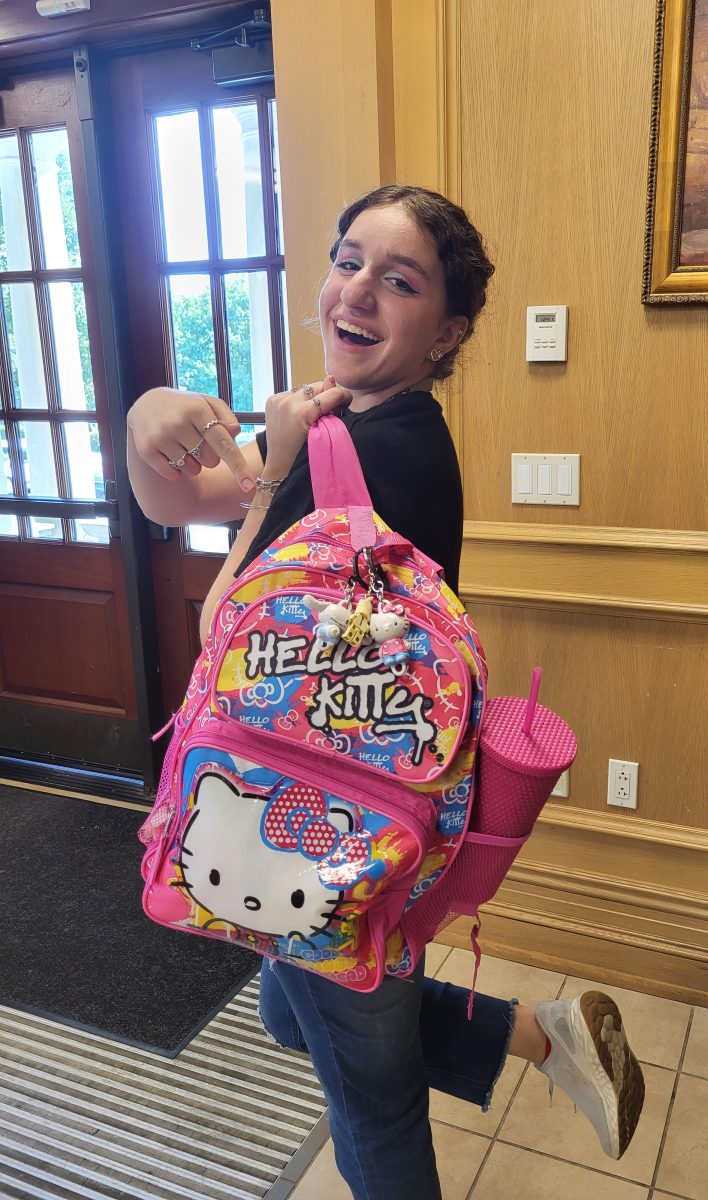 Senior Angela Croce proudly shows off her 'Kiddie Senior Backpack' featuring Hello Kitty.