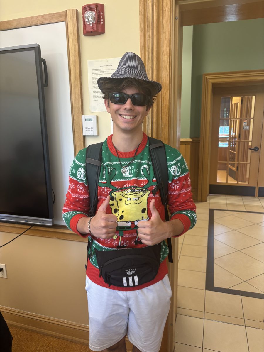 Senior Ethan Niewinski dressed up for "Clash Day." He paired a Christmas sweater with an Adidas fanny pack and a fedora. Other students clashed different colors and patterns.