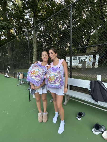 Senior tennis captains Isabella Barriera and Frances Clifford showcase their matching My Little Pony backpacks on the tennis courts. This fun activity allowed some to team up with friends and match with them. Their coordinated backpacks show the friendship and spirit shared among the senior athletes.