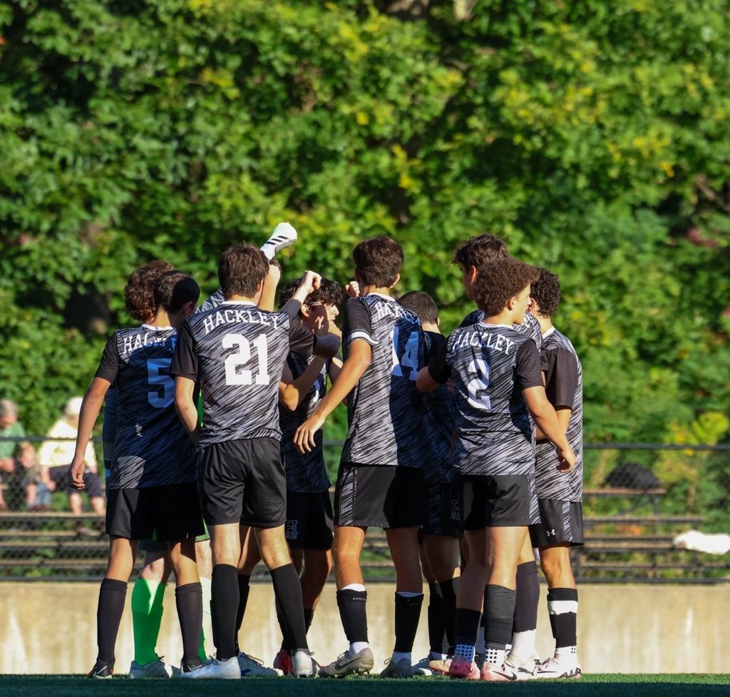 Boys Varsity Soccer huddles before each game to gather the energy and get connected. This was before their first Ivy Prep League win this season against Collegiate, coming out strong with a 3-0 score. 