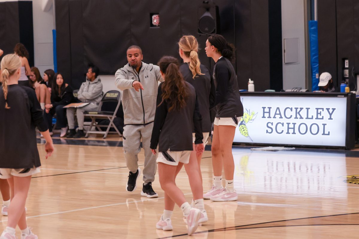 Coach Jeffrey leads his Varsity Girls' Basketball team in warm ups before a difficult game against Poly Prep. The team fought hard, but lost 58-30. 