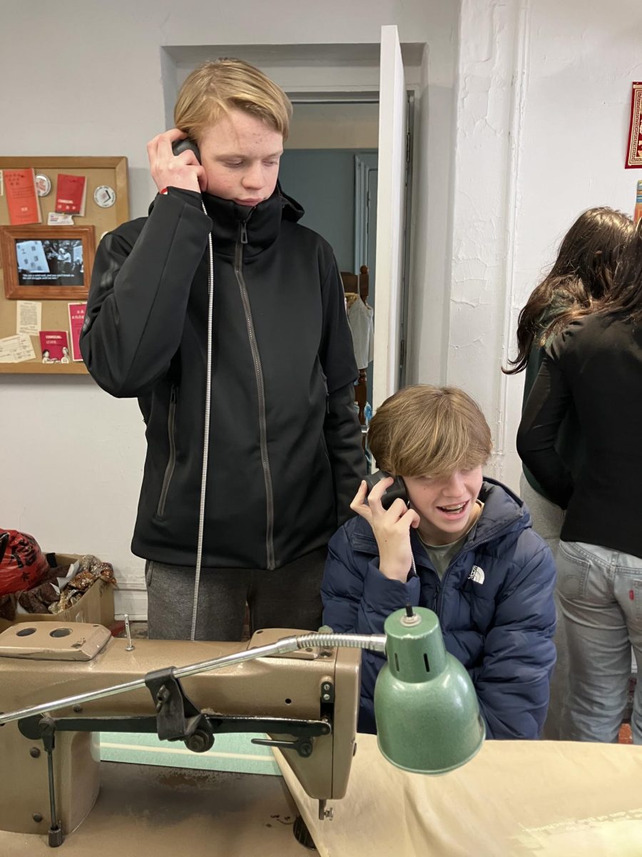 Sophomores Theodore Anderson and Alex Aybar use headsets to listen to the stories of Asian immigrants who had previously lived in the same Tenement building during the Twentieth Century. 