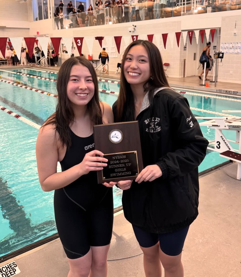 Varsity Swim seniors Kayce Park and Meredith Lee proudly hold up the NYSAIS runners up plaque after completing their last season on the team. After an undefeated season, the team fought hard during the NYSAIS tournament. With NYSAIS being one of the hardest events of the season, they just fell short of the 1st place finish.