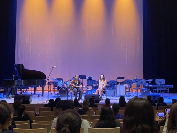 Freshman Farah and sophomore Riya perform "Watch" by Billie Eilish.  Farah played her guitar while Riya led the audience in clapping to the beat of the song. The two talented underclassmen put on an impressive act to start the evening.