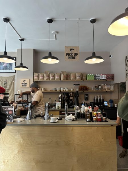 This is the interior of the cafe. Upon entrance, customers are greeted by the baristas and can observe them making drinks while figuring out what to order.