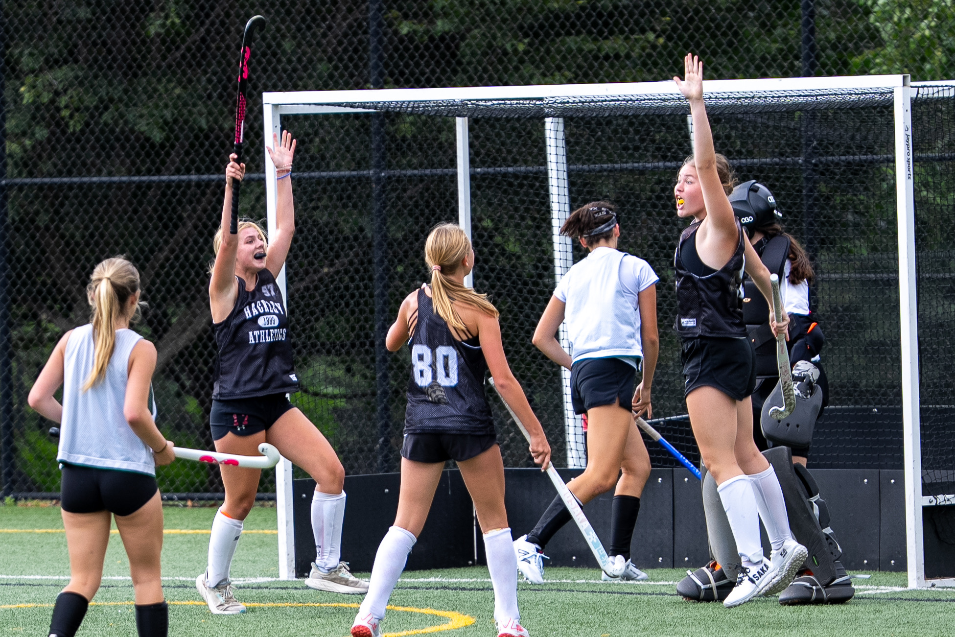 Charlotte Frazier, 10th grade, Adelle Hostetler, 9th grade, and Erin O’Rourke, 8th grade, all members of the girls field hockey team. They are celebrating their goal made during preseason. Showing the connection and support between grade levels.
 (Photo courtesy of Sarah Sichel-Outcalt)