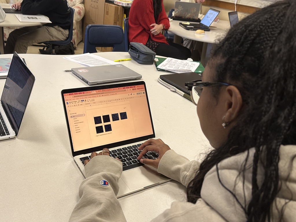 Senior Nima Jones works on her research paper. Over the summer, she created a disease model of fat and bone cells to help find a healthy baseline of  those cells. She plans to submit her research paper to the Columbia Junior Science Journal and the PennScience High School Journal.