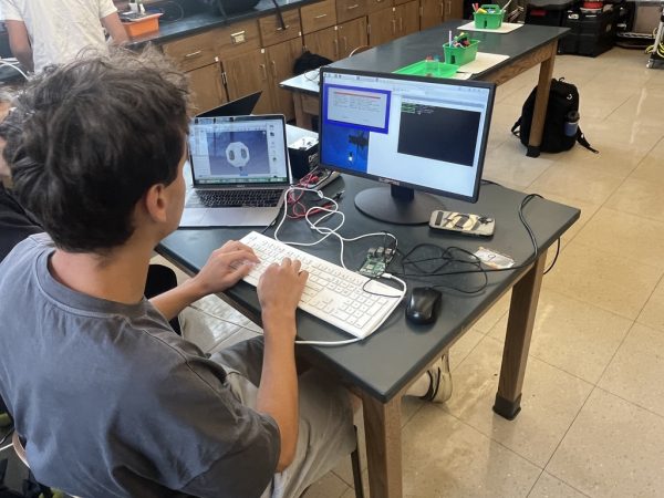 Because the ROV class only officially meets once a cycle, students also often come in during lunch periods. Mateo spends a lot of his time teaching various skills to others and ensuring everyone is productive. Here, he has connected the Raspberry Pi to the monitor, and on his laptop has a model of the ROV.