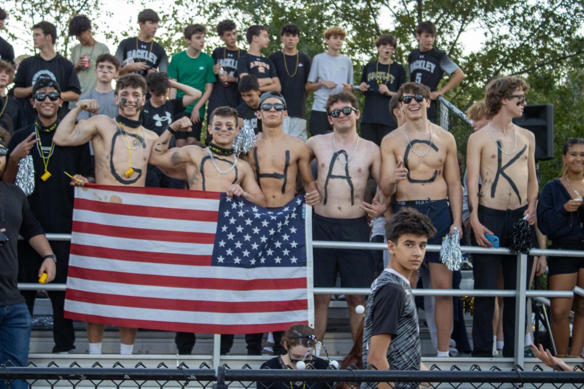 The stands were covered in students sporting their black, white, and yellow decorations for the night game. Some senior boys even participated in "Go Hack" letter painting.