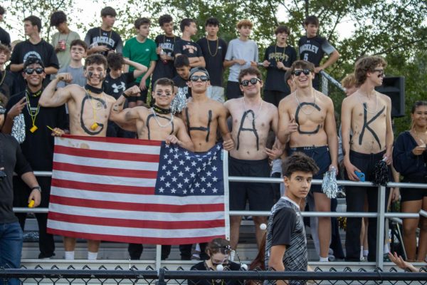 The stands were covered in students sporting their black, white, and yellow decorations for the night game. Some senior boys even participated in "Go Hack" letter painting.