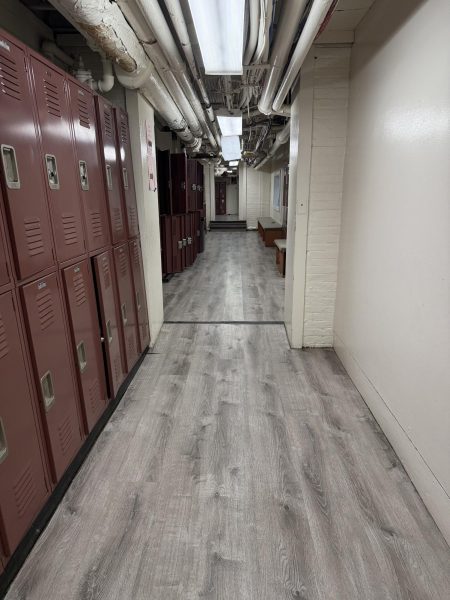 This is the Freshman Hallway, a location central to 9th-grade life, with lockers and seating. Often, it is criticized for its low, exposed pipes and unkept appearance.